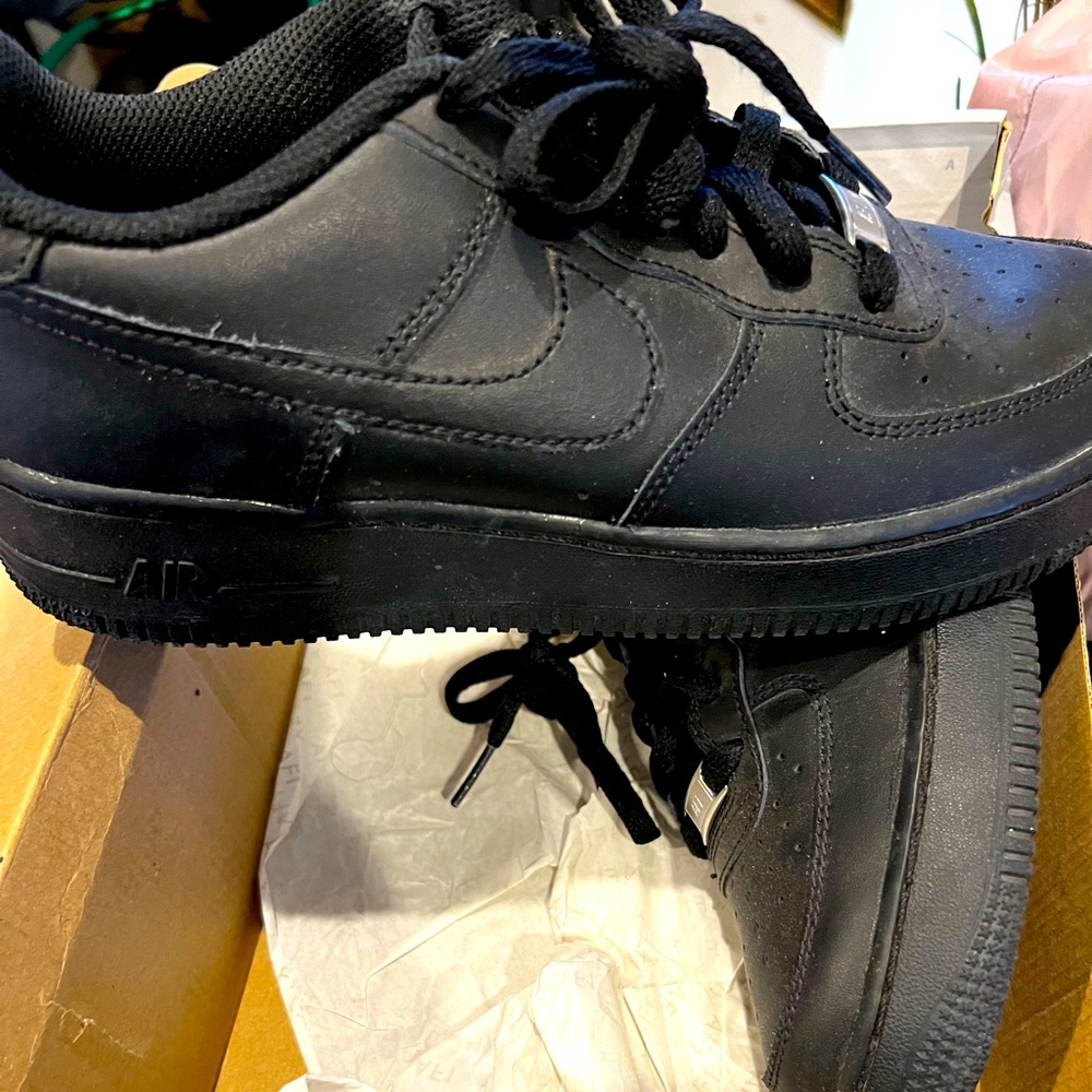 Black low top Nike Air Force Ones kids